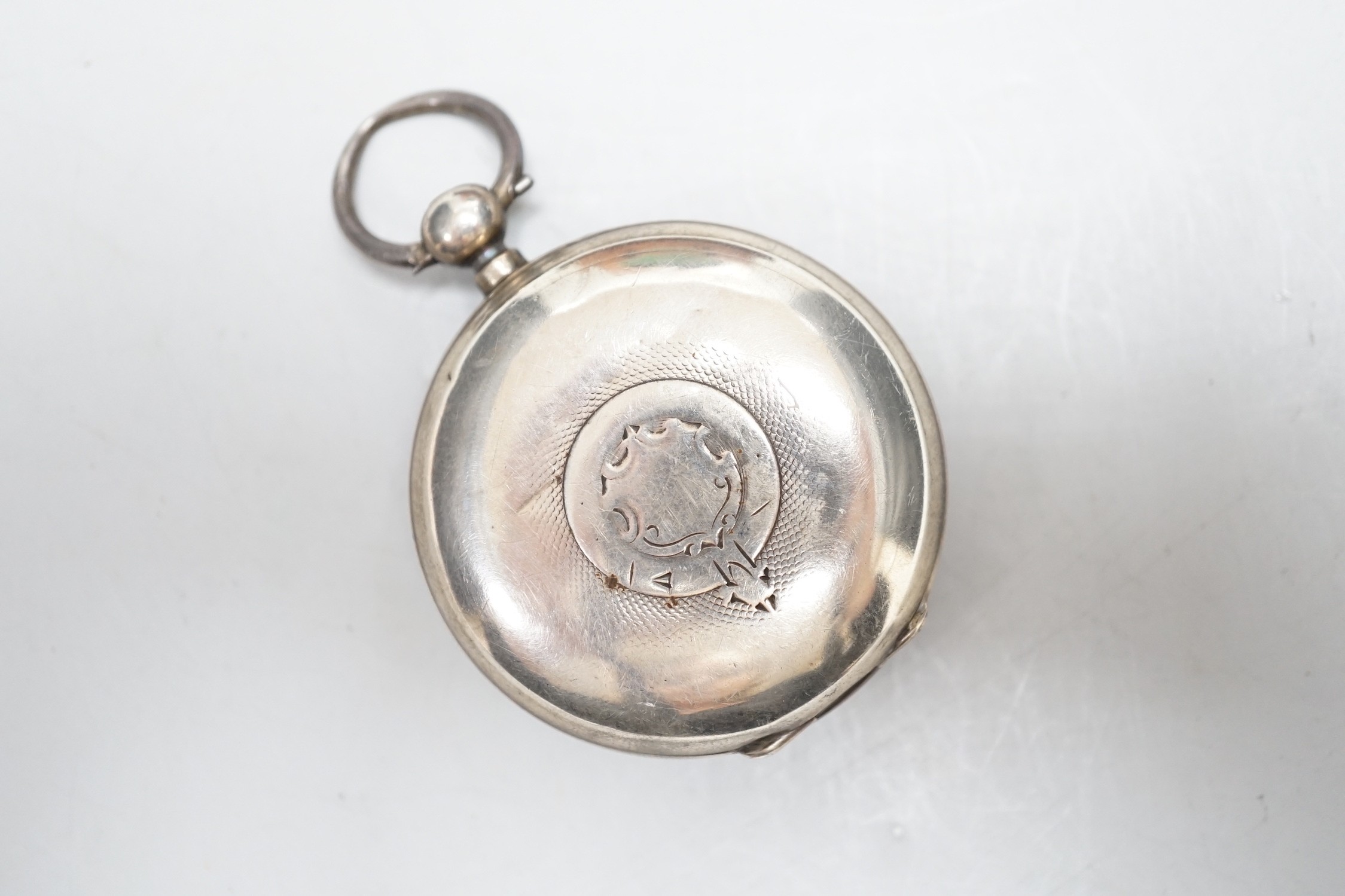 A silver pocket watch and holder